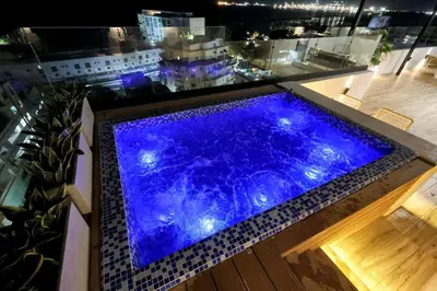 a blue swimming pool on top of a building at Lujoso Penthouse frente a la Playa de Boca Chica in Boca Chica