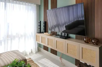 a living room with a large flat screen tv at Lujoso Penthouse frente a la Playa de Boca Chica in Boca Chica
