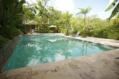 a swimming pool with blue water in a yard at JardinesDelMontSerrat-LasTerrenas-NearBeach Cozy 2BR-3BDS-6PAX-WiFi in Las Terrenas
