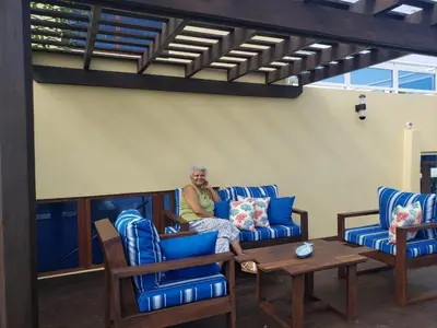an older woman sitting on a couch in a living room at My Deligth in San Felipe de Puerto Plata