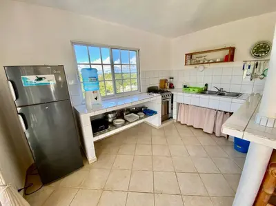 a kitchen with a stainless steel refrigerator in it at Casa Blanca Samaná - Las Galeras in Las Galeras