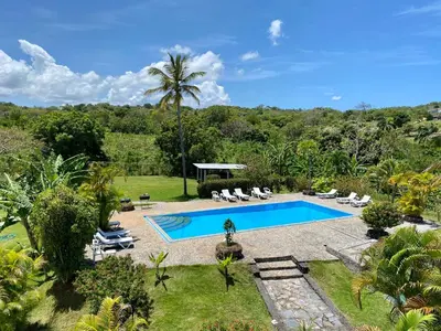 an image of a swimming pool in a garden at Casa Blanca Samaná - Las Galeras in Las Galeras