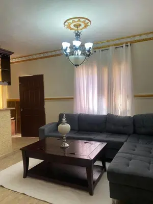 a living room with a blue couch and a coffee table at casa en Puerto Plata para 2 in San Felipe de Puerto Plata