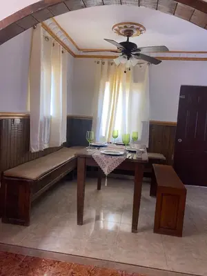 a dining room with a table and a ceiling fan at casa en Puerto Plata para 2 in San Felipe de Puerto Plata
