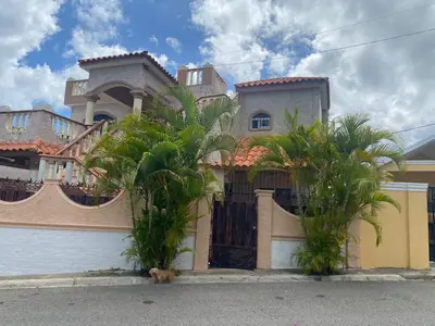 a large house with palm trees in front of it at casa en Puerto Plata para 2 in San Felipe de Puerto Plata