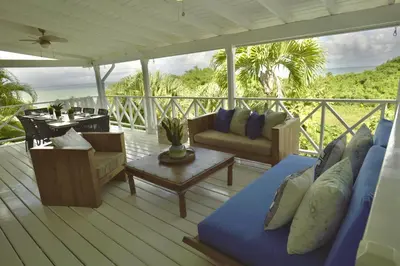 a porch with a couch and a table on a deck at Villa Valentine LomaBonitaLasTerrenas in Las Terrenas
