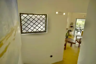 a room with a window on the wall and a table at Villa Valentine LomaBonitaLasTerrenas in Las Terrenas