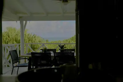 a porch with chairs and a table with a view at Villa Valentine LomaBonitaLasTerrenas in Las Terrenas