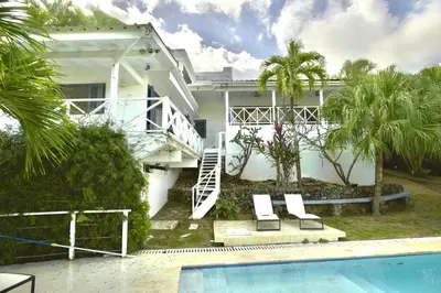 a white house with a swimming pool in front of it at Villa Valentine LomaBonitaLasTerrenas in Las Terrenas
