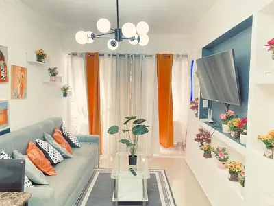 a living room with a couch and a tv at 13 de las Americas in La Alianza