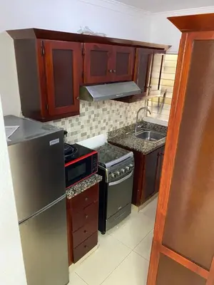 a small kitchen with a stove and a sink at 13 de las Américas in La Alianza