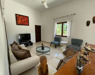 a living room with a couch and a table at Okaina 7 Penthouse in Cabarete