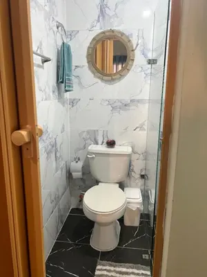 a bathroom with a toilet and a mirror at Hostal Bless house in San Pedro de Macorís
