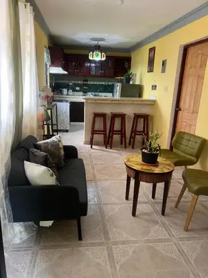a living room with a couch and a table at Hostal Bless house in San Pedro de Macorís