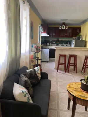 a living room with a couch and a table at Hostal Bless house in San Pedro de Macorís