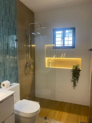 a bathroom with a toilet and a glass shower at Mila's House in La Romana