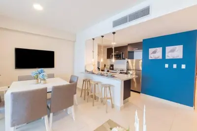 a kitchen and dining room with a table and chairs at Luxury Beachfront 2BR at Las Olas, Juan Dolio in La Puntica de Juan Dolio