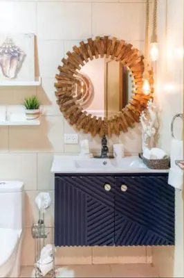 a bathroom with a mirror and a blue sink at Luxury Beachfront 2BR at Las Olas, Juan Dolio in La Puntica de Juan Dolio