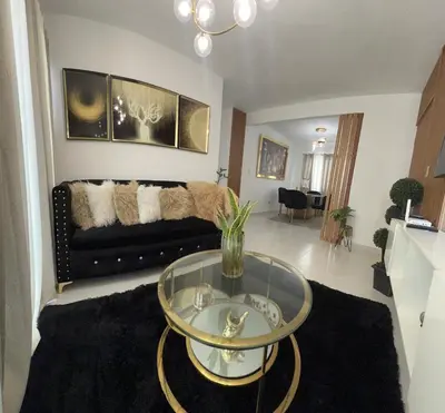 a living room with a couch and a glass table at Hermoso y amplio apartamento de 3 habitaciones y 2 baños ! in San Pedro de Macorís