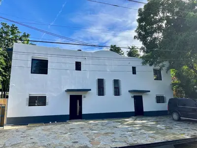a white building with black doors and windows at Brandnew 3 BR villa in Cabarete in Cabarete