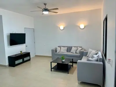 a living room with a couch and a tv at Brandnew 3 BR villa in Cabarete in Cabarete