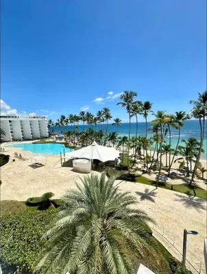 a resort with a pool and palm trees and the ocean at Marbella-SeaView-FrontBeach-Cozy-2Br-2Bds-4Pax-WiFi in Villas del Mar