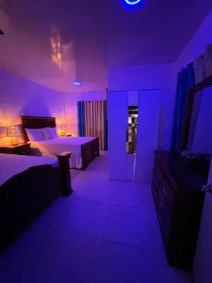 a purple room with two beds and a sink at Villa Jarabacoa in Concepción de La Vega