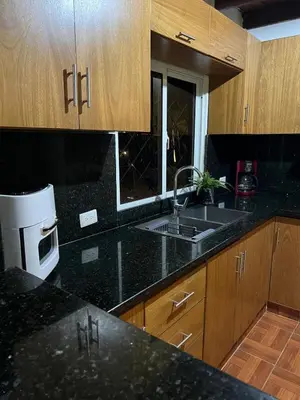a kitchen with a sink and a microwave at Villa Jarabacoa in Concepción de La Vega
