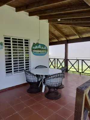 a patio with a table and chairs on a porch at Vacacional las pascualas in Sánchez