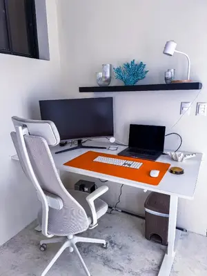 a desk with a computer and a laptop on it at Kaleidoscopic Apartment in La Majagua