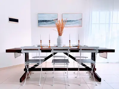 a dining room table with chairs and a vase with candles at Rooftop, Pool View, Walk to Beach, Dining, Shops in Punta Cana