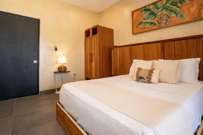 a bedroom with a large white bed in a room at VillaVida Boutique Hotel - La Playita in Las Galeras