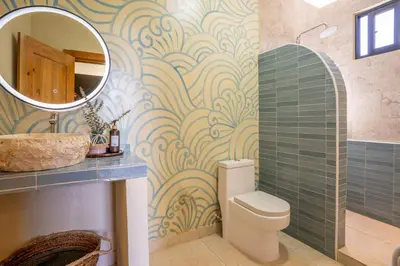a bathroom with a toilet and a sink and a mirror at VillaVida Boutique Hotel - La Playita in Las Galeras