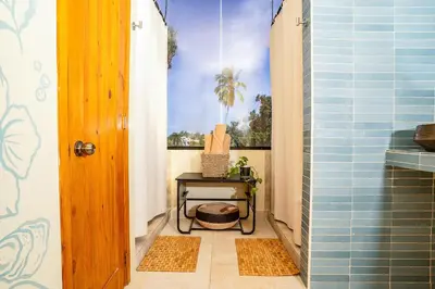 a small bathroom with a table and a window at VillaVida Boutique Hotel - La Playita in Las Galeras