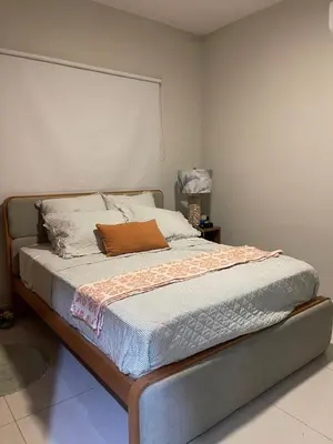 a bed in a bedroom with avertisementatronatronstrationstrationstration at modern y acogedor in San Felipe de Puerto Plata