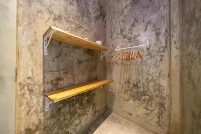 a shower with wooden shelves in a bathroom at REFUGIO Nature meets Luxury in Sabaneta de Yásica