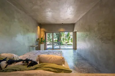a bedroom with a bed and a large window at REFUGIO Nature meets Luxury in Sabaneta de Yásica