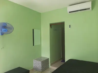 a room with a bed and a fan and a door at Tarde trankila in Sabana de Nisibón