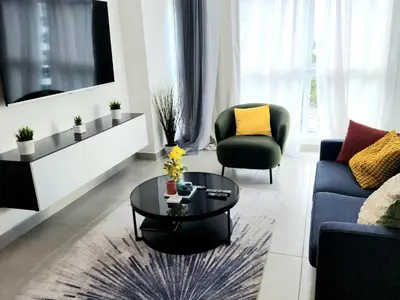 a living room with a couch and a table at Lindo 1BD apt in Bella Vista with Pool, Rooftop,Gym,Parking in Santo Domingo
