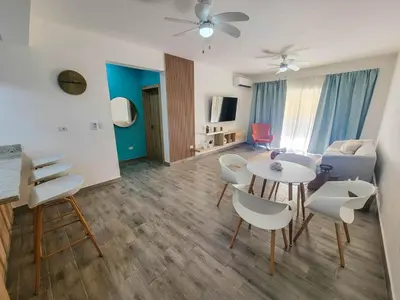 a living room with a table and chairs at Lovely Condo in Gated Community in Sosúa