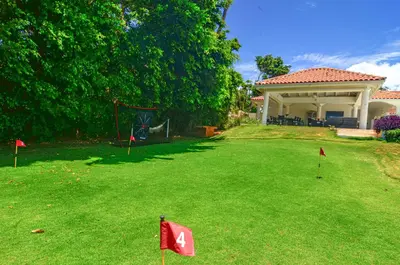 a yard with red flags in the grass at Cacique 13, Ocean View and Golf Course in La Romana