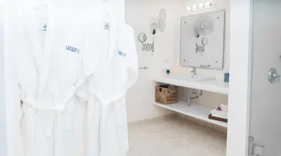 a bathroom with a white shower curtain and a sink at Cacique 13, Ocean View and Golf Course in La Romana
