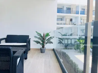 a room with a table and a potted plant in a building at Dream pool views apartment close to the beach in Punta Cana
