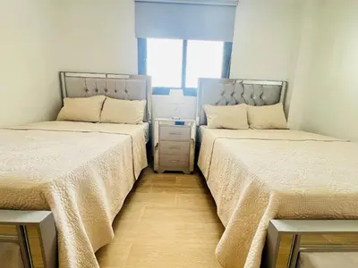 two beds sitting next to each other in a bedroom at Dream pool views apartment close to the beach in Punta Cana