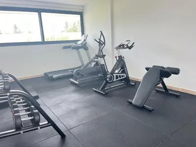 a gym with three exercise bikes in a room at Dream pool views apartment close to the beach in Punta Cana