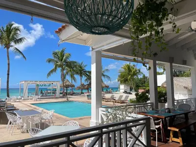 a view of the pool and ocean from the patio of a resort at 2BR 2BA Beachfront 63 in Bayahibe