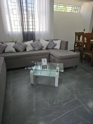 a living room with a couch and a glass table at Andys Villa in Naime 3 in San Pedro de Macorís