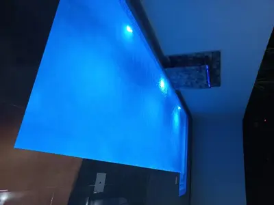 a blue light on the side of a wall at Andys Villa in Naime 3 in San Pedro de Macorís
