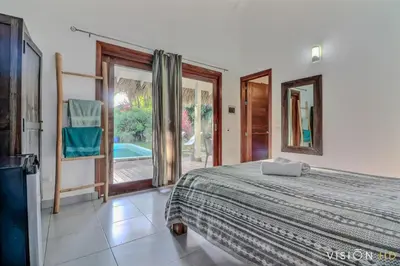 a bedroom with a bed and a large window at Casa Zebra lovely villa near the beach in Las Terrenas