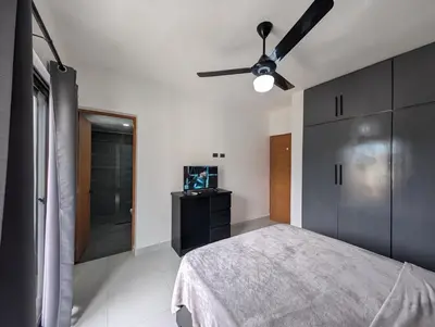 a bedroom with a bed and a ceiling fan at 2-bedroom apartment with 24h electricity and private parking in Sosúa